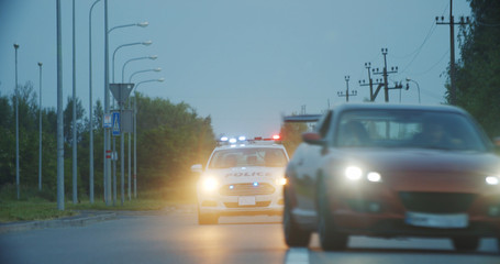 High speed police pursuit on highway. View of cop patrol car chasing a thief on red modern car driving away from the law. © Fractal Pictures