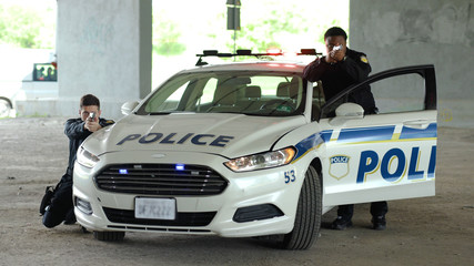 Teamwork two policemen leave the patrol car pulling pistols danger dangerous delinquent gangster gun gunpoint handgun hold illegal intruder law offender burglar close up slow motion © Fractal Pictures