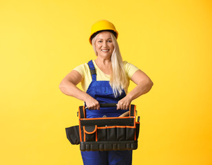 Female worker on color background. Concept of feminism