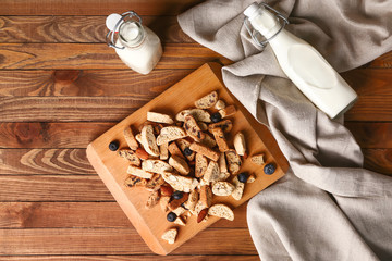 Sweet cookies and milk on wooden table