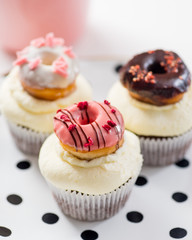 cupcakes with icing and small decorative donuts