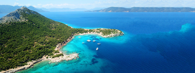 Aerial drone ultra wide photo of paradise small island of Moni visited by sail boats and yachts...