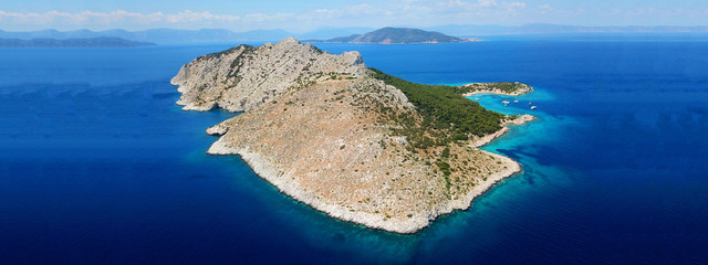 Aerial drone ultra wide photo of paradise small island of Moni visited by sail boats and yachts...
