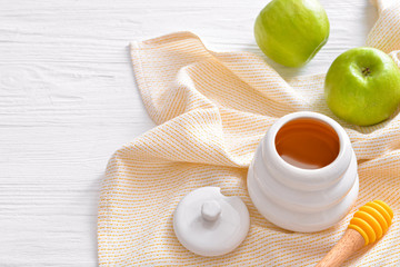 Sweet honey and apples on table