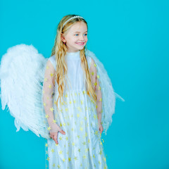 Little angel Girl in white dress with angel wings on isolated background. Christmas Cute little...