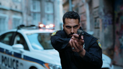 Hands young man cops hold pistol stand near patrol car look at camera enforcement happy officer police uniform auto safety security communication control policeman close up slow motion © Fractal Pictures