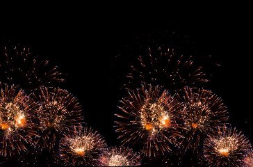 golden fireworks on black background with sparks