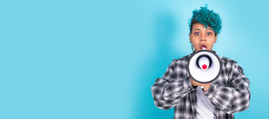 african american girl or woman with megaphone isolated on blue background