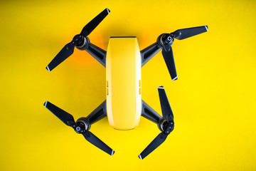 Yellow drone on a yellow background. Small pocket drone.