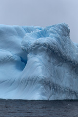 Layers of textured ice on an iceberg - 322650422