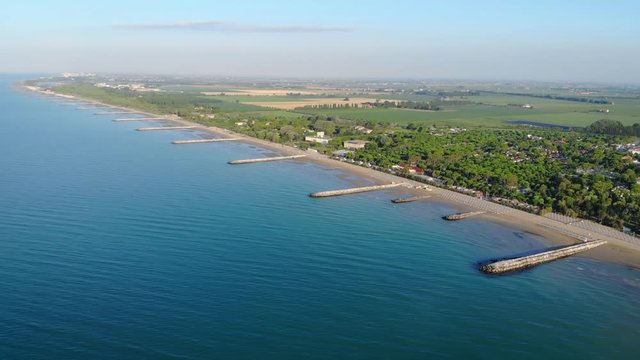 Aerial shot of the coast of Caorle and the rural area surrounding the city of Venice at sunrise
