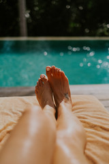Beautiful female pedicure on the background of the pool