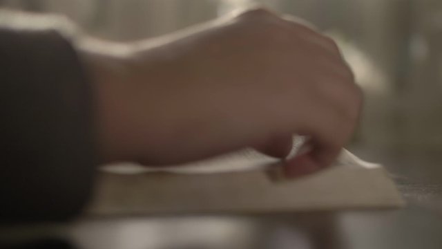 woman reads a book, turns over the pages, copy space