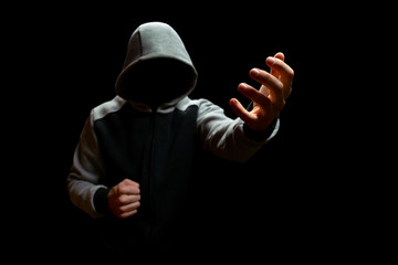 An unknown criminal in the hood is trying to take away someone else's