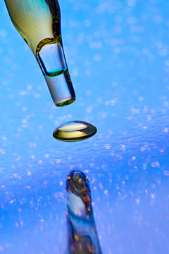 Studio shot of glass dropper with drop of CBD oil