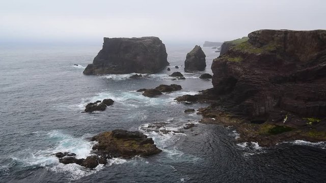 Sea stacks and cliffs in the mist at Eshaness / Esha Ness, peninsula in Northmavine on the island of Mainland, Shetland Islands, Scotland, UK