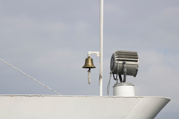 There is a lighting projector and warning bell on the ship.