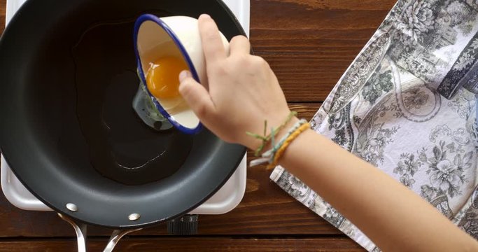 Top view food. Cooking With Mother. Beautiful Little Girl Learns How To Make Fried Egg.