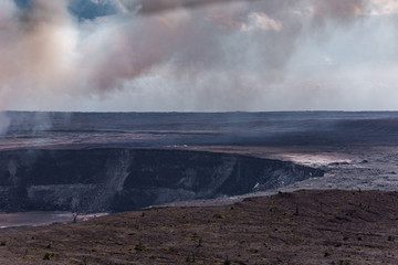 Brown and white flume hangs over Halemaumau crater, Kilaeuea volcano, Hawaii,, USA.