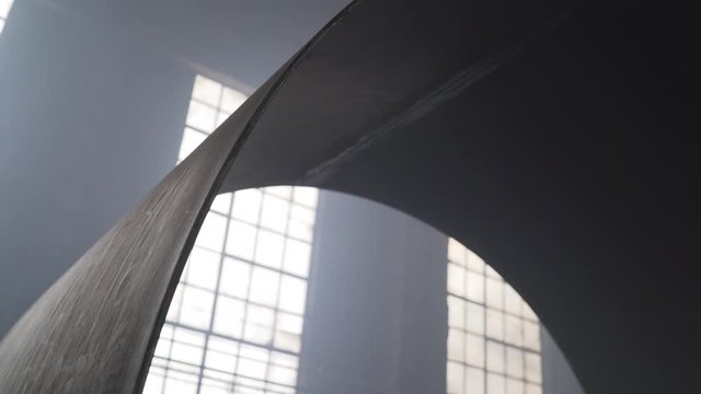 Large diameter metal pipe in the production room. Production of large metal pipes.