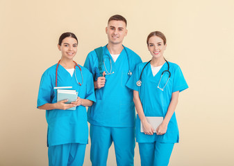 Group of medical students on light background