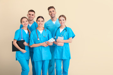 Group of medical students on light background