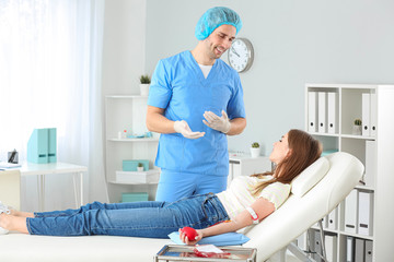 Woman donating blood in hospital