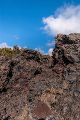 1961 Lava pile under blue cloudscape, Kilaeuea volcano, Hawaii,, USA.