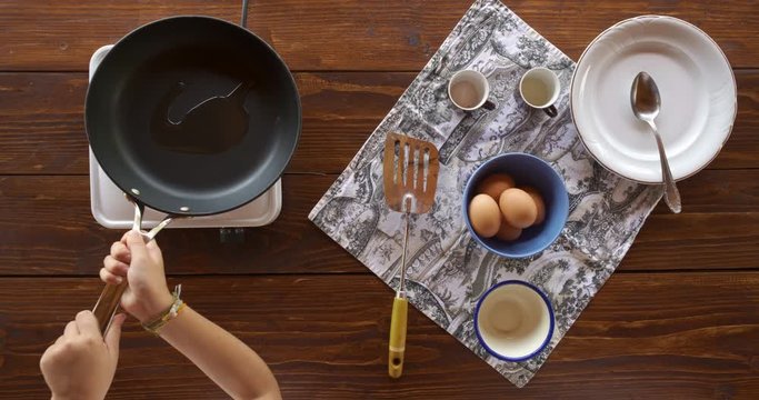 Top view food. Cooking With Mother. Beautiful Little Girl Learns How To Make Fried Egg.