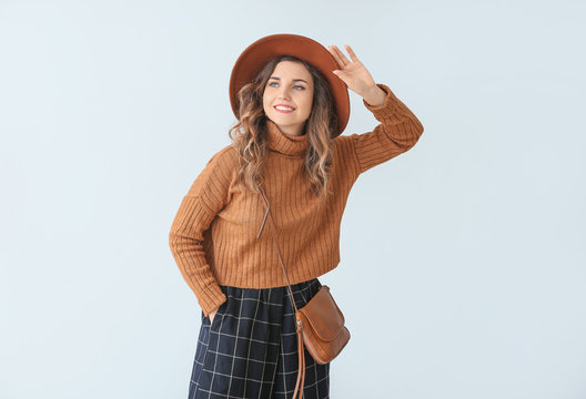 Beautiful Young Woman In Warm Sweater On Light Background