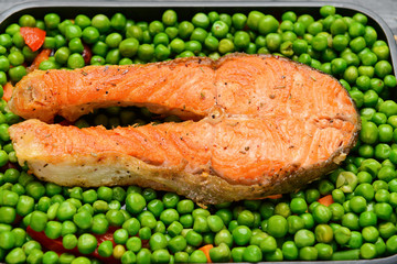 Tasty salmon and peas in baking dish