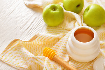 Sweet honey and apples on table