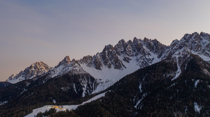 Dolomites Mountain in winter, by San Candido, Alto Adige Italy. Sunrise in Monte Baranci Haunold. Aerial drone shot in january 2020