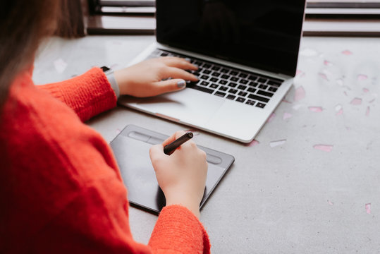 partial view of woman retouching on drawing tablet