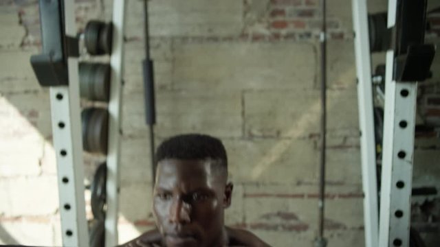 Close up of shirtless African American man doing front squats