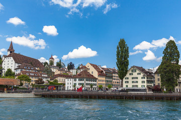 Beautiful view of the old town of Lucerne on the river side of Reuss, with the famous Musegg wall (Museggmauer) and tower on a sunny summer day with blue sky cloud, Switzerland