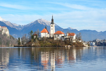Lake Bled Slovenia. Beautiful mountain lake with small Pilgrimage Church. Most famous Slovenian lake and island Bled with Pilgrimage Church of the Assumption of Maria and Bled Castle in background.
