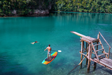 SUP boarding. Sugba lagoon, tourists attraction. Beautiful landscape with blue sea lagoon, National Park, Siargao Island, Philippines.