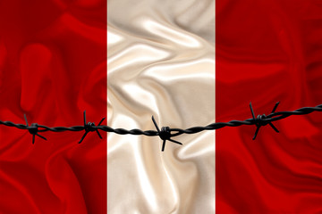 iron barbed wire against the background of the national silk flag of the state of Peru, concept...