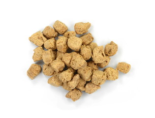 Raw dehydrated soy meat on white background. Pieces of dry soy meat. Textured Soy Protein.