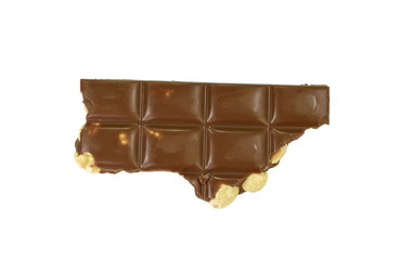 A broken piece of chocolate with hazelnuts isolated on white background. Milk chocolate tiles with nuts isolated on white.
