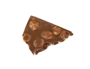 A broken piece of chocolate with hazelnuts isolated on white background. Milk chocolate tiles with nuts isolated on white.