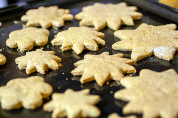 Close up shot of star shaped cakes on an owen tray
