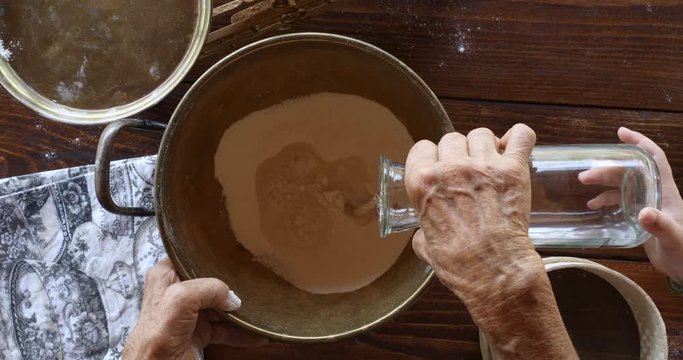Top view preparing food. Cooking With Grandma. Beautiful Little Girl Learns How To Make Cookies.