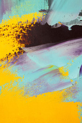 Textured background of oil paint in yellow and blue tones, selective focus