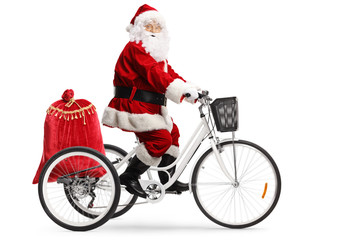 Santa Claus riding a tricycle with a sack of presents