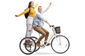 Happy young male and female on a tricycle