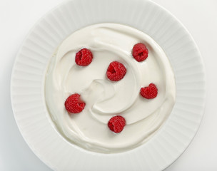 plate of greek yogurt with raspberries