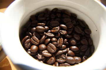 coffee beans in a ceramic container in daylight