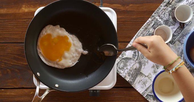 Top view food. Cooking With Mother. Beautiful Little Girl Learns How To Make Fried Egg.